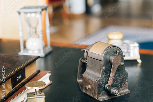 Vintage antique pencil sharpener on a dark desk