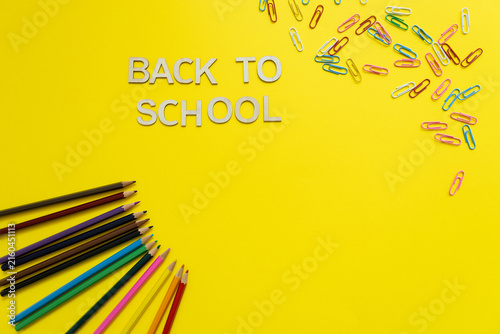 Foto yellow background  with pencils and with back to school text