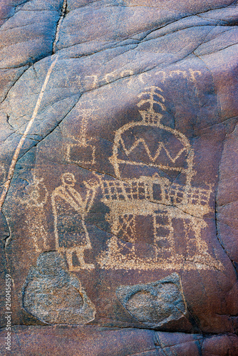 View of an ancient petroglyph depicting a stupa and a human figure etched into a dark rock surface along the Karakoram Highway in Chilas, Gilgit Baltistan, Pakistan.