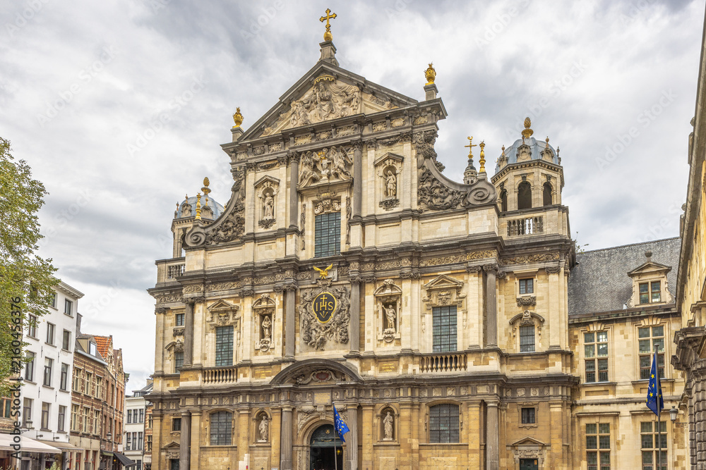 Fototapeta premium Antwerp town in Belgium, Europe. Grand Baroque Architectural Facade with Ornate Carvings Under a Dramatic Sky, Showcasing Historical European Design and Craftsmanship