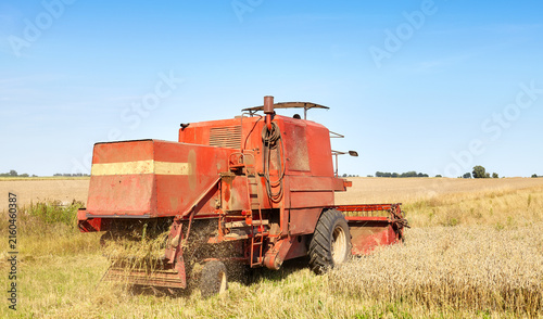 Combine harvesting wheat on a sunny summer day.