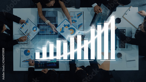 Quadro su tela Professionals collaborate in a corporate meeting analyzing data charts and graphs, striving to enhance growth and performance through informed decision-making