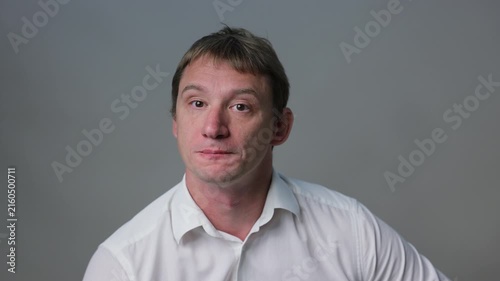 Businessman in a suit looking at the camera and smile. Studio portrait isolated on a white background, suitable for business, stress andal concepts.