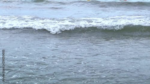 Ocean waves crashing on a sandy beach