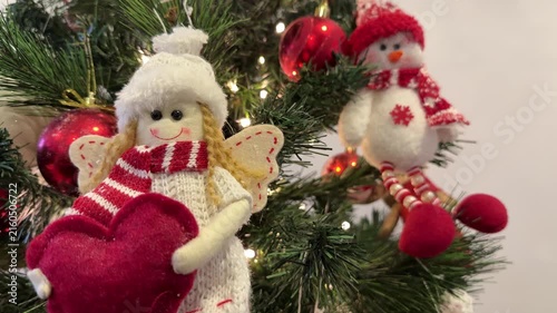 Christmas tree with Santa ornaments and red baubles, festive decor close up