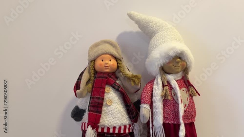 Two winter dolls in hats and scarves, cozy Christmas decoration
