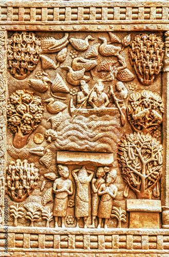 Narrative Buddhist relief depicting a river crossing or sacred water journey scene with birds, lotus vegetation, devotees, and nature motifs, carved on the Torana of the Great Stupa at Sanchi, Sanchi
