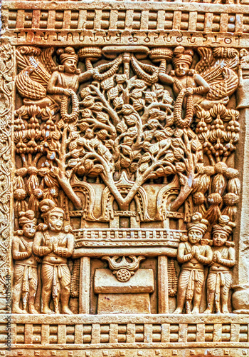 Sacred Bodhi Tree (Tree of Enlightenment) above the Vajrasana (Diamond Throne), worshipped by devotees and celestial beings in an aniconic Buddhist relief from Sanchi, Sanchi, India