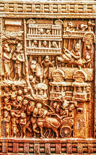Ancient Buddhist narrative relief depicting an urban settlement with multi-storey buildings, processions, animals, and daily life scenes carved on the Torana of the Great Stupa at Sanchi, Sanchi.