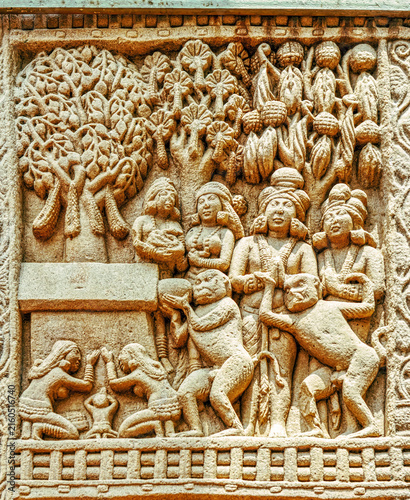 Aniconic Buddhist relief depicting devotees venerating a sacred Bodhi Tree shrine with nāga worshippers, attendants, and ritual offerings, symbolizing the Enlightenment of the Buddha, from Sanchi