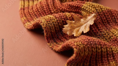Cozy Warm Knit Texture with Autumn Leaf on Earthy Background