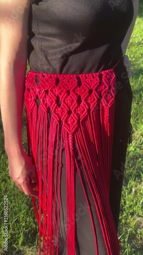 Woman wearing a stylish handmade red macrame belt