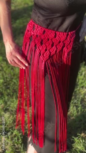 Woman wearing a stylish handmade red macrame belt