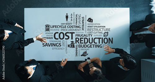 Fotografie A top-down view of a business meeting where professionals discuss cost reduction and budgeting strategies to enhance operational efficiency and drive savings