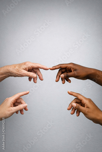 Multi-ethnic people showing support with a high five gesture against a neutral background.