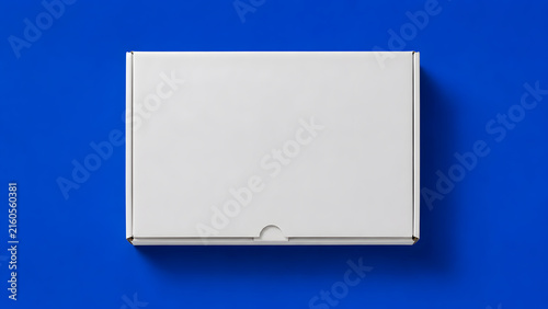 Minimalist white cardboard box packaging on vibrant blue background, product presentation mockup, clean flat lay composition, top view isolated design, modern branding template for e-commerce