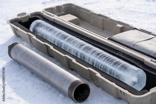 Bild auf Leinwand Layered ice core resting in a padded transport tray on polar snow