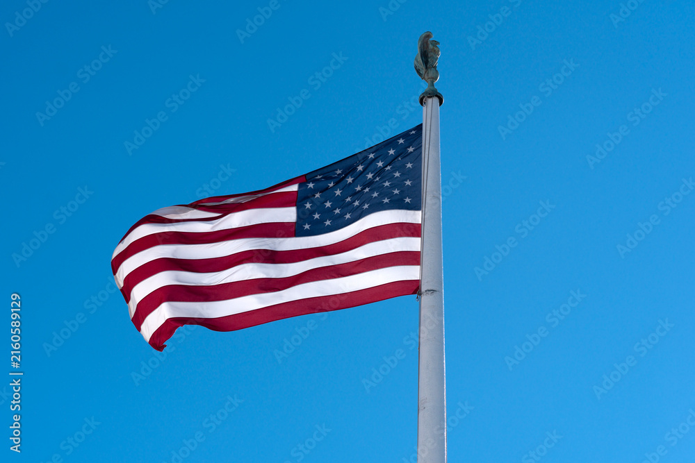 Obraz premium Flag American waving blue background. American patriotic freedom banner flag. USA democracy liberty concept flag. American culture independence flag.