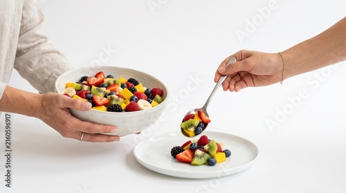 Fresh Fruit Salad Being Served From Bowl to Plate with Spoon