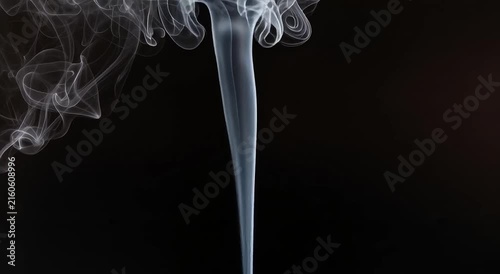 Smoke swirl motion rising against a solid dark black background captured as high quality professional cinematic abstract video footage