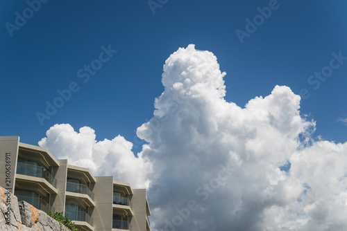 Towering Cumulus Clouds Above Coastal Building
