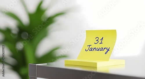 January 31 date written on yellow sticky note in a bright minimalist office setting with sharp focus for business planning and schedule management