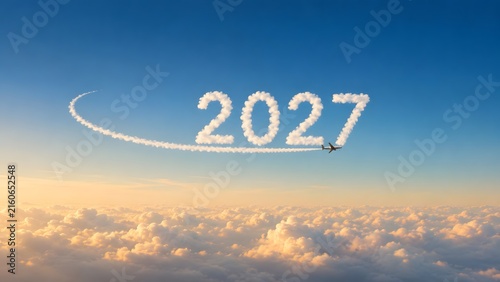 Year 2027 Cloud Text Formed By Airplane Contrail Over Fluffy Clouds At Sunset