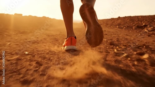 Golden sunset jog on dusty trail with running legs and dog paws