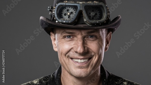 Portrait of Smiling Man in Vintage Top Hat with Goggles