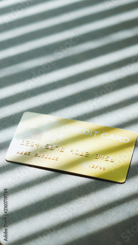 E-commerce Payment, Golden credit card with natural sunlight shadow effect for payment concept.
