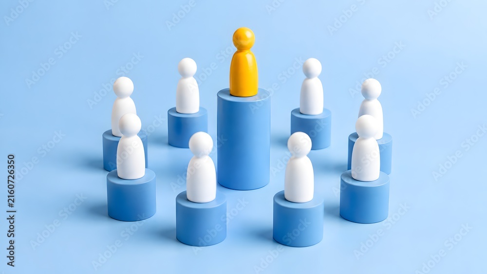 Obraz premium Yellow Leader Peg Figure Standing On Central Tallest Blue Podium Surrounded By Team