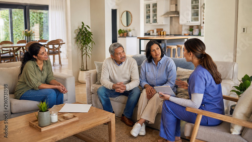 Family discussing care plan with nurse at home