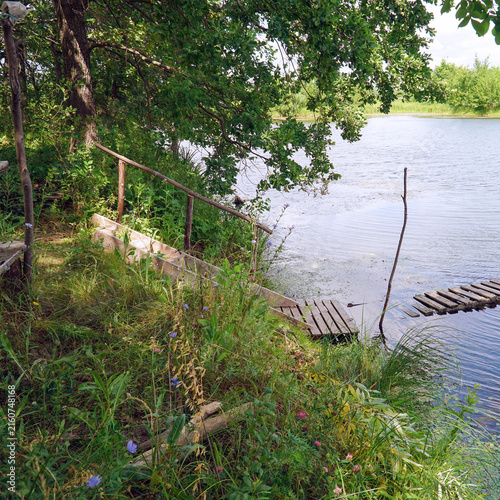 Wooden pier on a calm lake shore