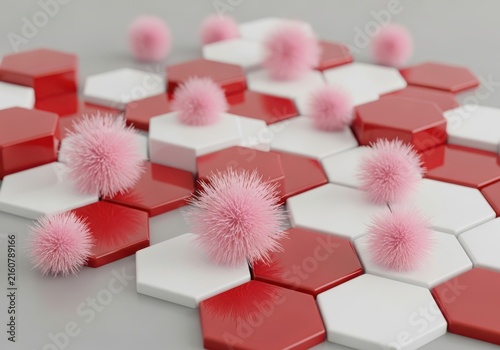 Pink fluffy pompoms resting on a geometric pattern of red and white hexagons
