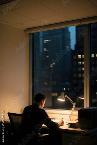 Focused Night Work by City Window