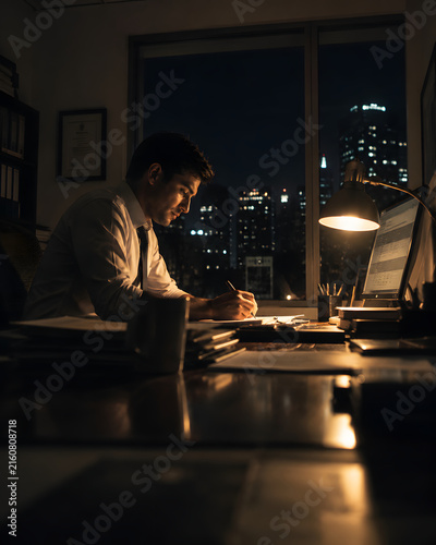 Focused Night Work by City Window