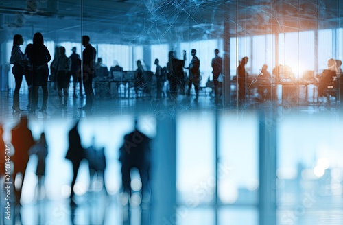Blurred silhouettes of people in modern office spaces, connecting ideas
