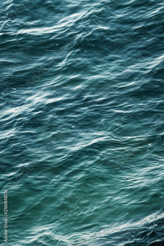 Принти на полотні Close-up view of textured ocean surface with gentle waves, teal-blue sea water a