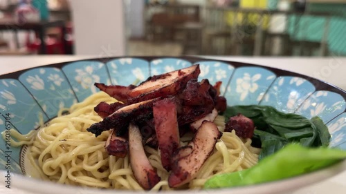 Close up view of noodle on the bowl. chicken charsiu and mustard greens leaves. side, front. mie, bakmi.
