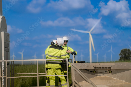 Cuadro en lienzo A technician leans forward over the guardrail of a steel platform to look down a