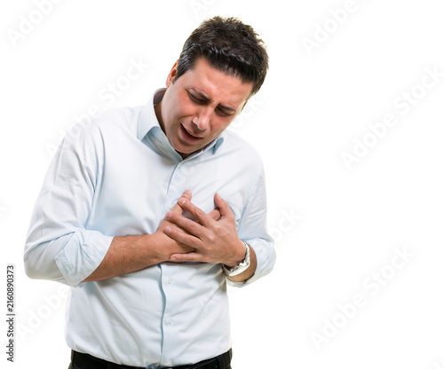 Obraz na płótnie Portrait of a man holding his chest in pain suffering from heart attack isolated on white background