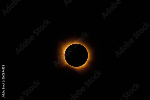 Total solar eclipse showing solar corona and prominence and Baily's pearls