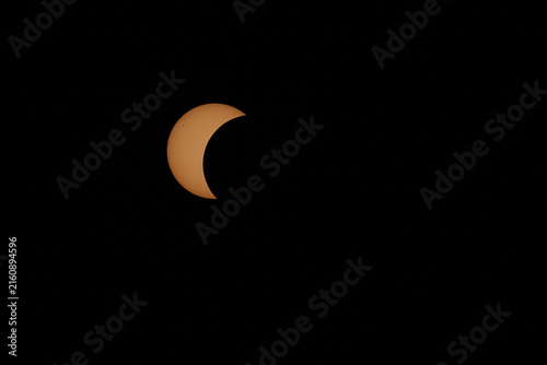 Partial solar eclipse with moon obscuring sun