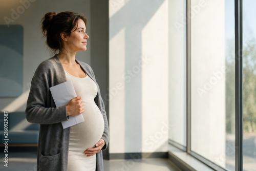 Pregnant Woman by Clinic Window After Routine Health Appointment
