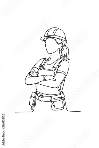 A woman in construction gear with her hands on her hips, ready to tackle a challenging work project.