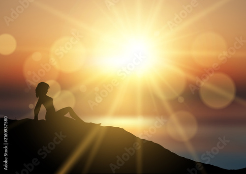 Silhouette of a female relaxing in a sunset landscape design