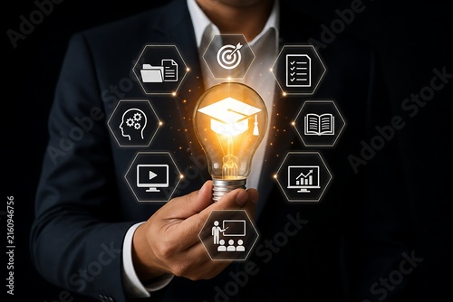 Hand holding a glowing light bulb with business and education icons