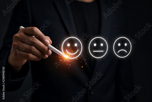 Hand drawing glowing smiley face icons in dark background with business suit