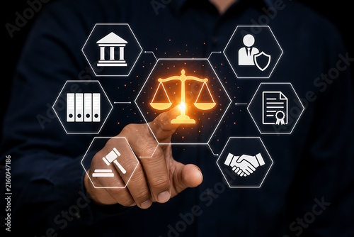Hand pointing at glowing justice scales and legal icons on a dark background