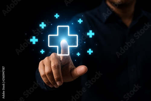 Hand pointing at glowing blue medical cross with plus symbols in dark setting